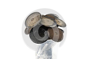 Old crooked motor valves standing in a plastic container shaped like a bouquet of flowers, isolated on a white background.