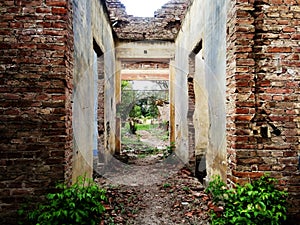 Old crumbling brick house in ruins