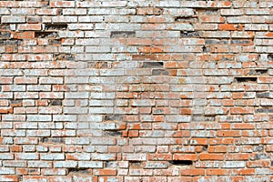 Crumbling brick wall made of ceramic red brick