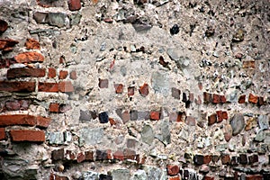 Old crumbling masonry wall with red bricks and stones.Old red brick wall, grunge background