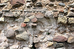 Old crumbling masonry wall with red bricks and stones.Old red brick wall, grunge background