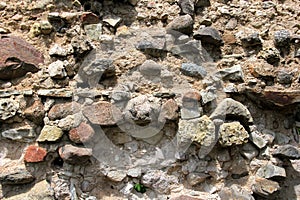 Old crumbling masonry wall with red bricks and stones.Old red brick wall, grunge background