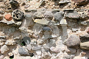 Old crumbling masonry wall with red bricks and stones.Old red brick wall, grunge background