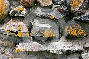 Old crumbling masonry wall with red bricks and stones.Old red brick wall, grunge background