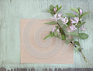 Old crumpled paper with pink flowers on grunge background