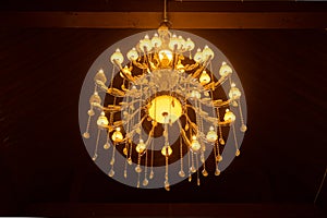 Old Crystal Chandelier on Ceiling with Warm Light