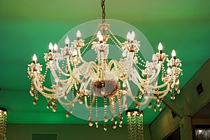 Old Crystal chandelier on green background