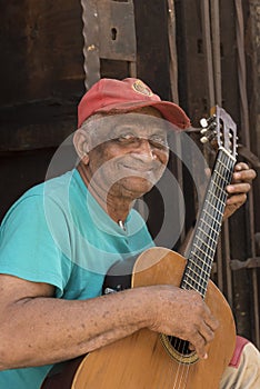 Old cuban man playing guitar Havana