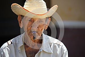 Old cuban man smoking a cigar