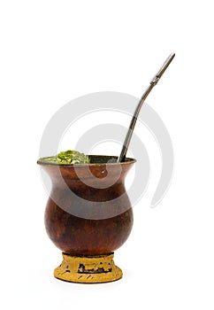 Old cuia with yerba mate and stainless steel pump, used to prepare the traditional chimarrÃ£o from southern Brazil.