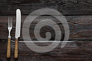 Old cutlery. On a wooden table background. Free space for text. Top view.