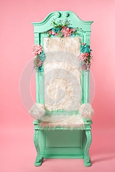 Old cyan throne on pink background.