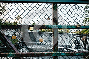 Old cyclone wire fence with padlocks