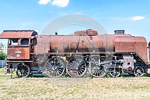 Old Czechoslovakian CSD steam engine on graveyard, rusty