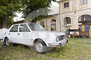 An old Dacia car in a marketplace  