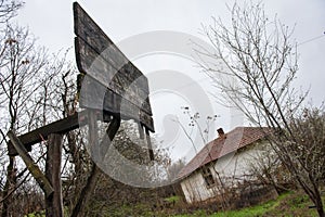 Old damaged basketball board in front of vintage abandoned house in the countryside