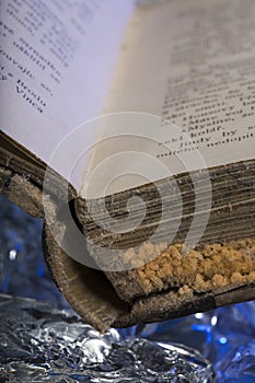 Old damaged book damaged on frozen ice