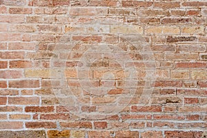 Old and damaged brown brick wall