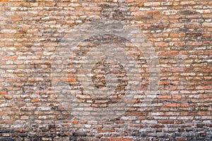 Old and damaged brown brick wall