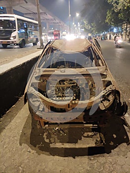 Old Damaged Car with only skeleton structure on roads in India