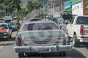 Old damaged car in urban part of Venezuela