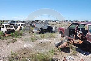 Old damaged cars in the junkyard. Car graveyard