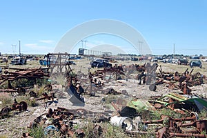 Old damaged cars in the junkyard. Car graveyard