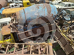 Old and damaged cars and machineries at a scrap yard