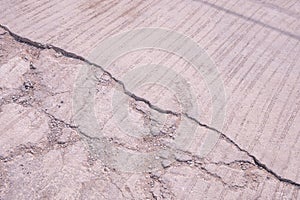 The old damaged concrete road background with broken and crack texture on surface