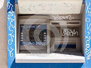 Old damaged destroyed vandalised outdoor ATM, vandalized cash machine detail, closeup. Economical crisis, financial recession