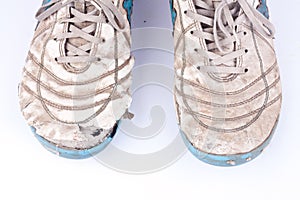 Old damaged futsal sports shoes on white background isolated close up