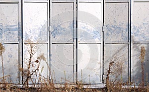 Metal gray folding door on an abandoned warehouse