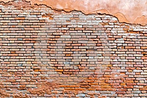 Old and damaged orange brown brick wall