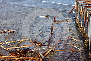 Old damaged pier garbage in water