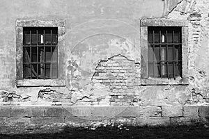 Old damaged wall with barred windows 4