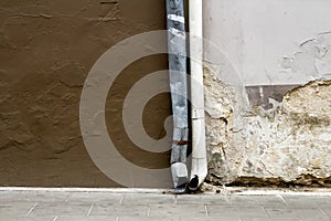 Old damaged wall and rain gutters background texture