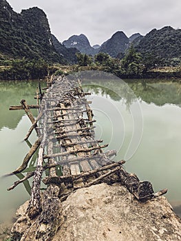 Old dangerous abandonned bamboo bridge crossing a river in the  Trung Khan District, Cao Bang Province, Vietnam