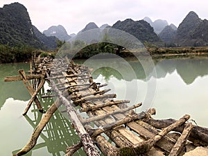 Old dangerous abandonned bamboo bridge crossing a river in the  Trung Khan District, Cao Bang Province, Vietnam