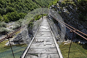 Old dangerous Swing Bridge in the dinaric alps of Albania