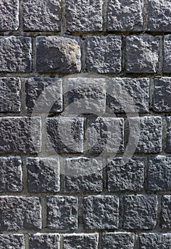 Old dark grey stone wall background texture