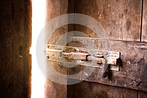 Old dark room with shining closed door.