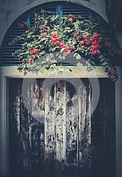 Old decay wooden door and flowers front