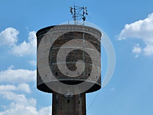 Old decaying brick tower functioning as radio tower