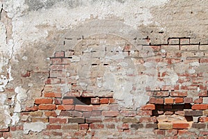 Old decaying concrete red brick exterior wall exposed