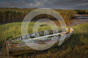 Old decaying wooden fishing boat photo
