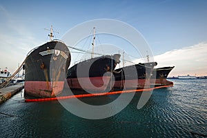 Old, decommissioned cargo ships in a row