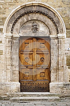 Old decorated wooden door of a church in Bevagna in Umbria Italy.