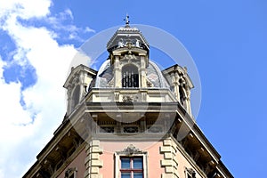 Old decorative roof dormer detail in Budapest. blue sky and white clouds