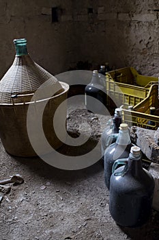Old demijohm and wine flasks in an ancient cellar