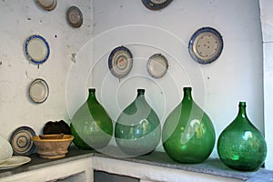 Old demijohns and wall plates